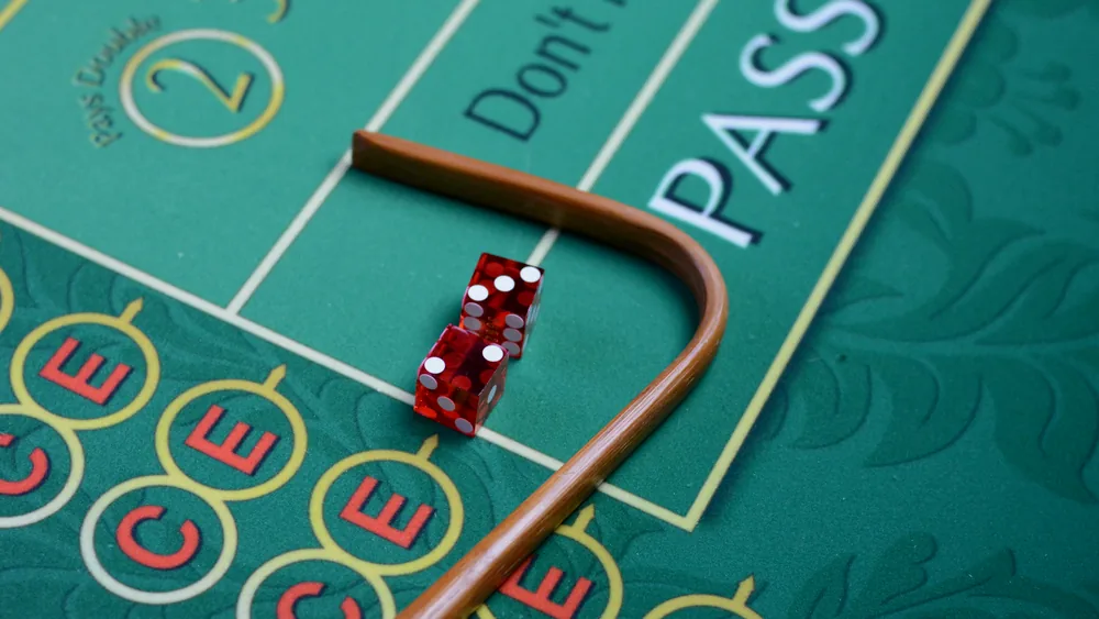 Craps-pöytä, nopat ja krupieerin keppi